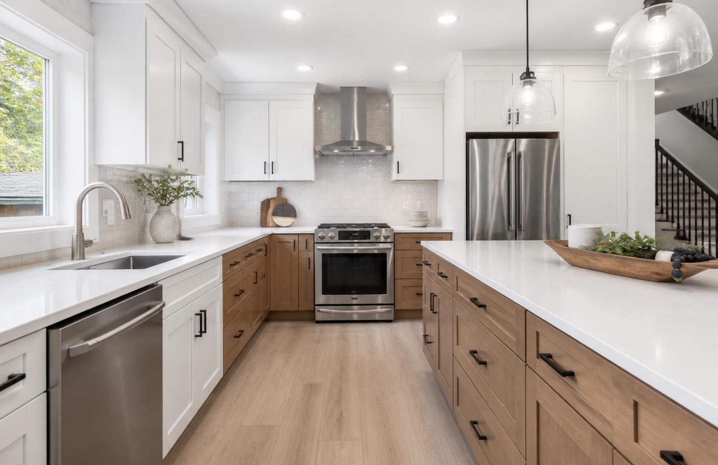 Renovated kitchen with white and oak cabinetry and quartz counters