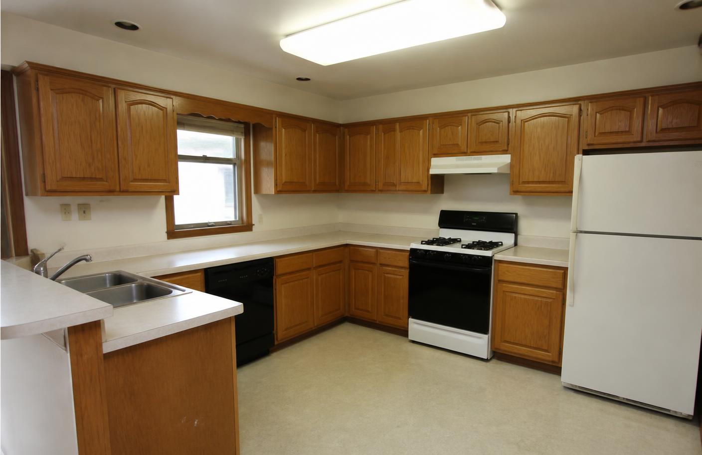 Dated kitchen with oak cabinets and laminate countertops